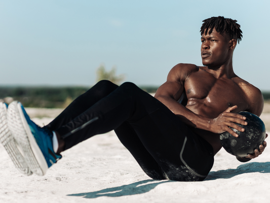 How to improve digestion: man doing crunches on the beach to support gut health and overall wellness.
